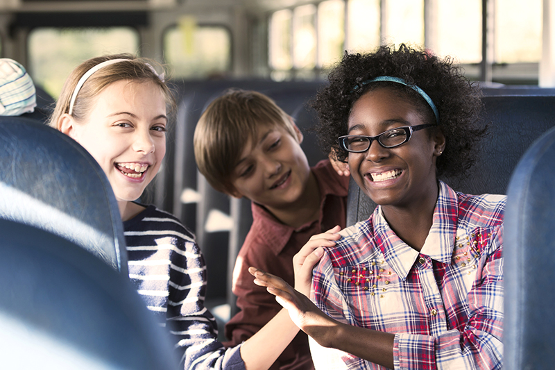 teenagers laughing on the bus