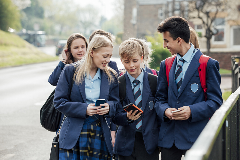 teenagers using their phones
