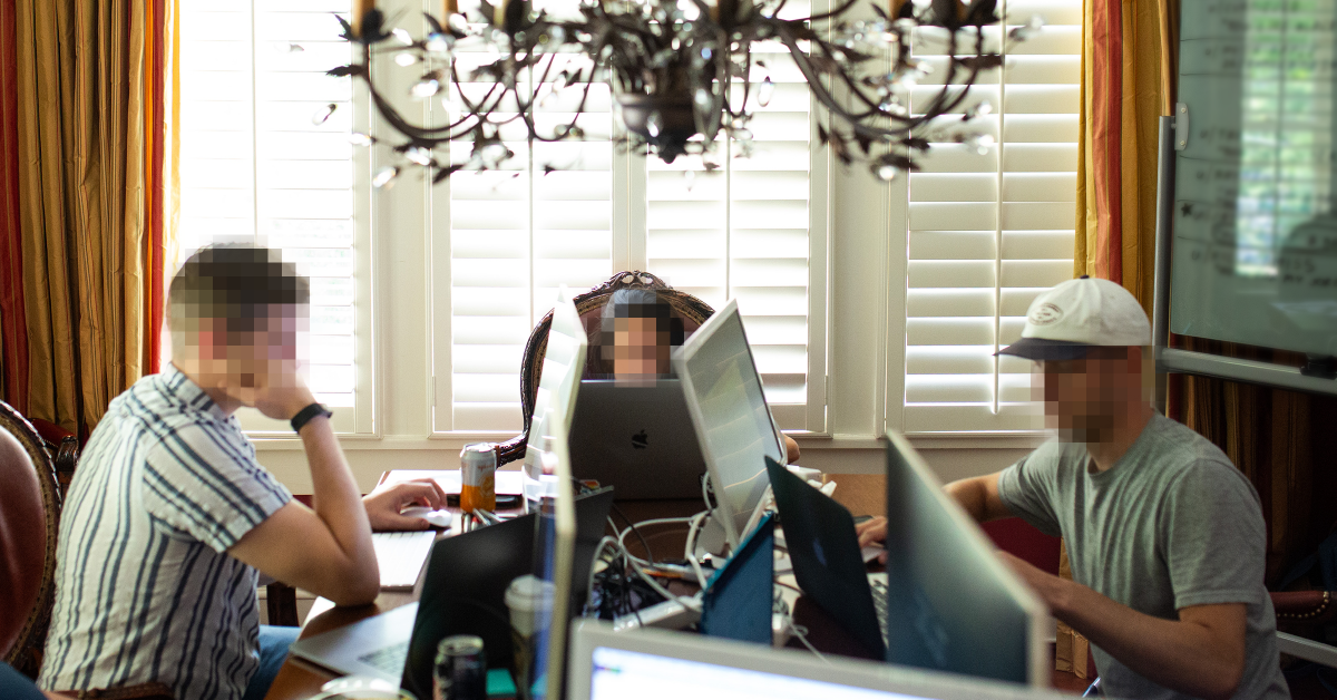 Sloane Ryan FAQs Three people with computers sit around a table