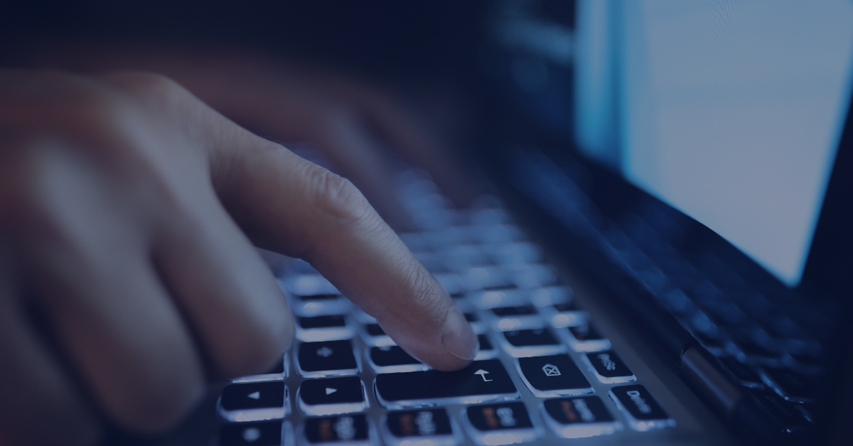 What Is Grooming A dark picture of a person's hands typing on a laptop