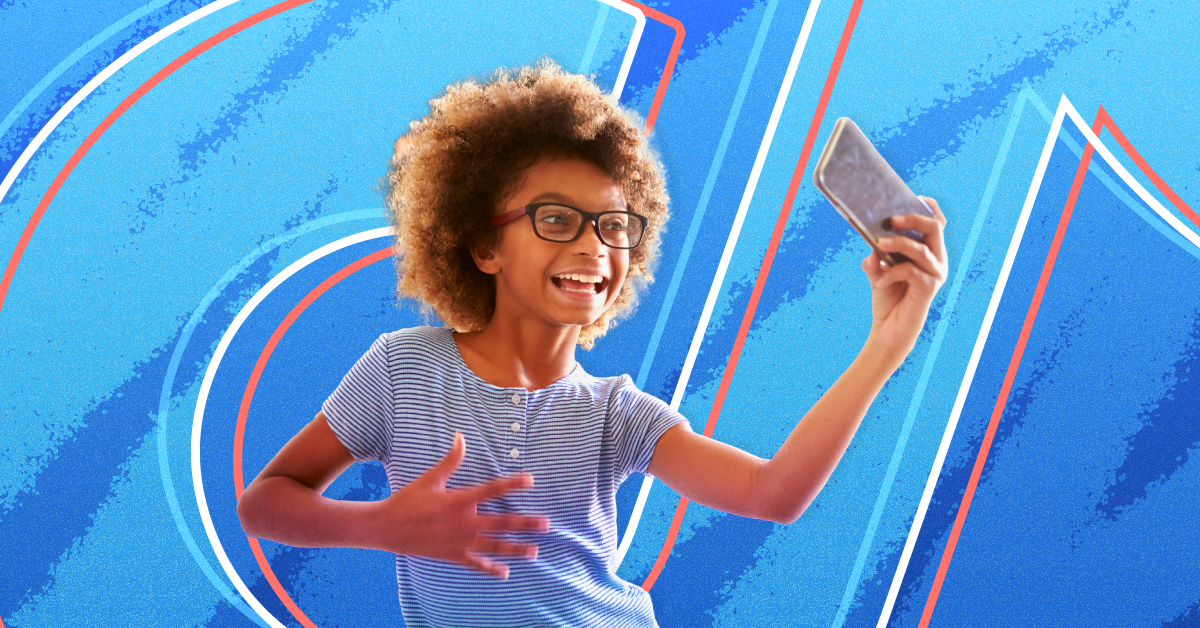 Kid-Friendly TikTok Accounts A young girl dances in front of her phone against an eggshell blue background with the TikTok logo on top
