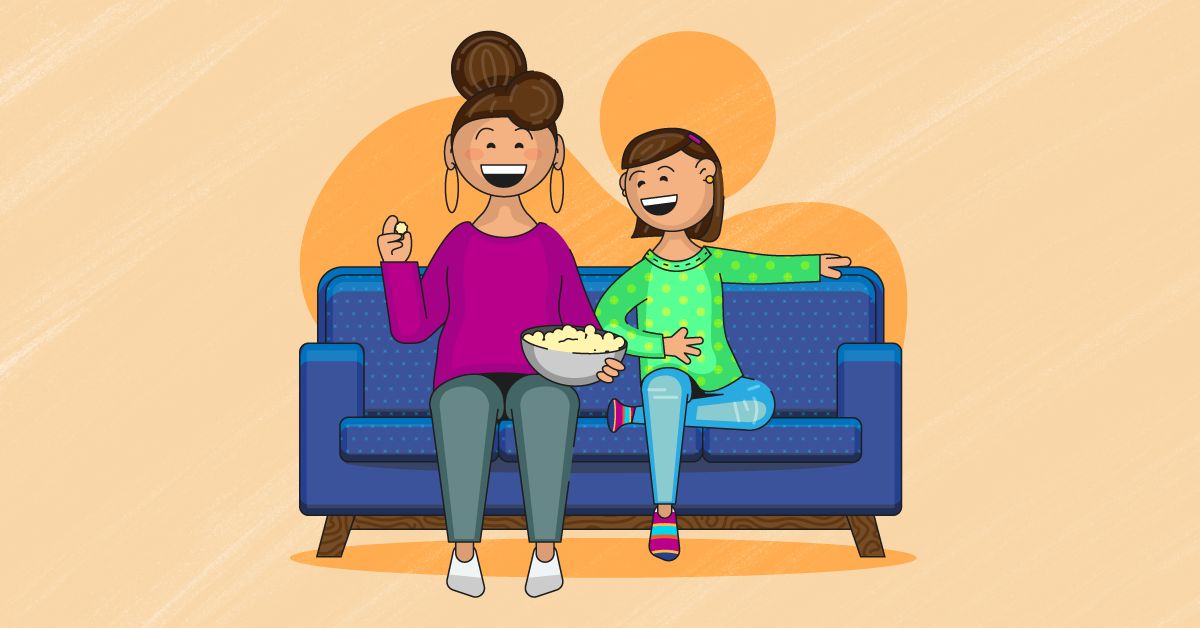 Importance of Family A parent and child sitting on a couch eating popcorn together