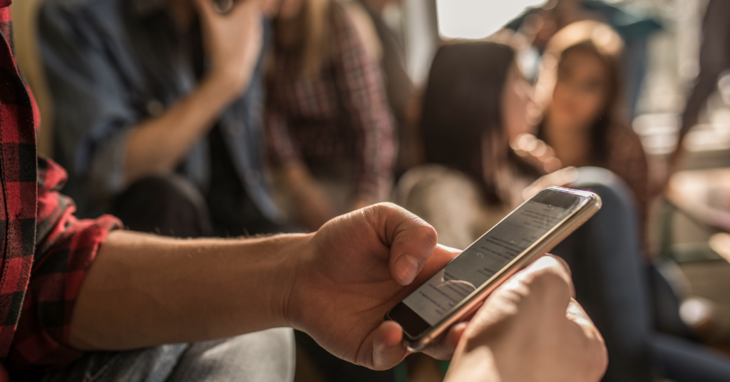 Teen sexting image of kid holding a phone