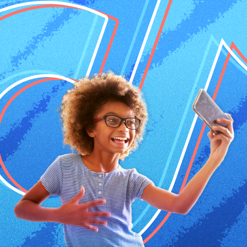 A young girl dances in front of her phone against an eggshell blue background with the TikTok logo on top
