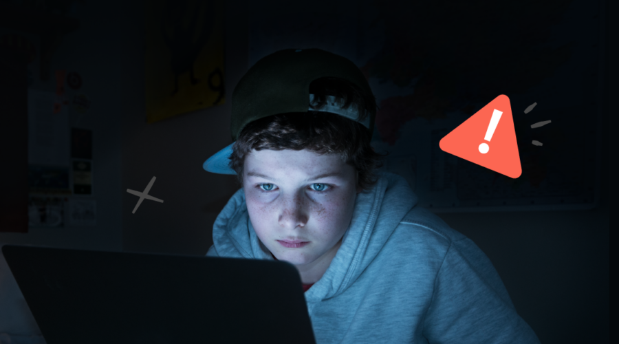 Illegal streaming sites header image of boy in front of computer in dark room