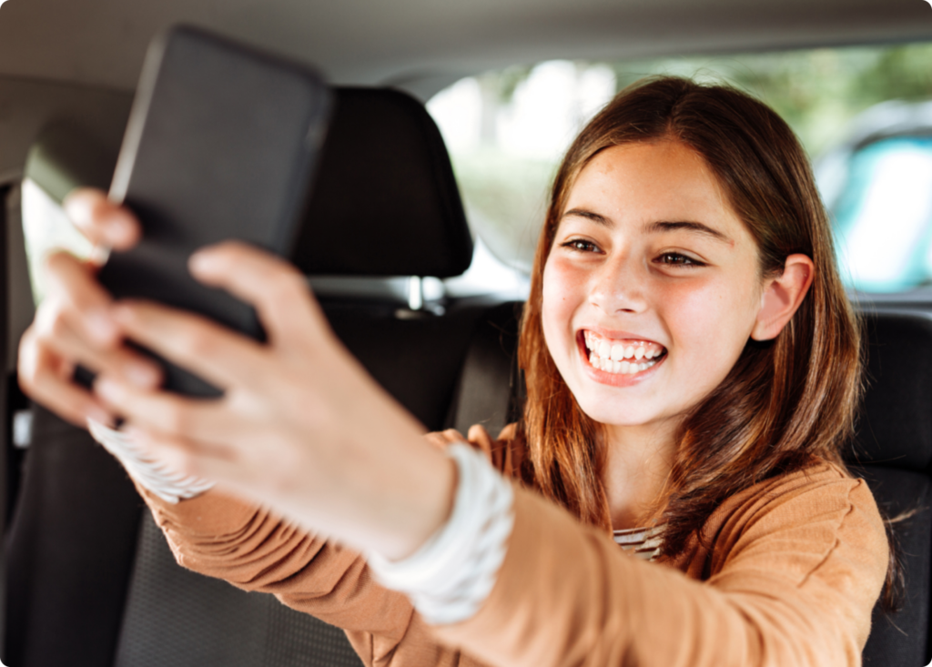 Girl taking a selfie while smiling with the Bark Kids' Phone