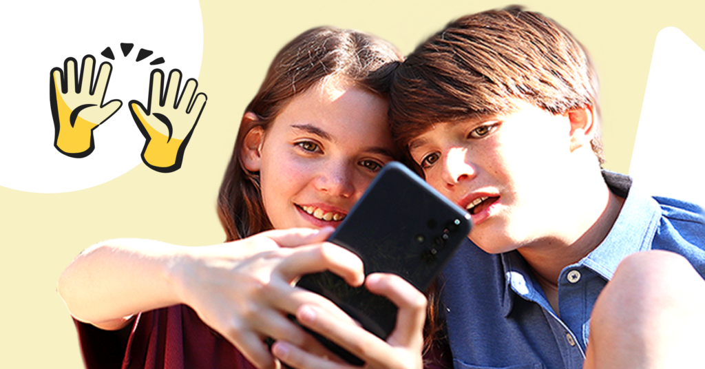 two kids looking at a phone - first cell phone header image
