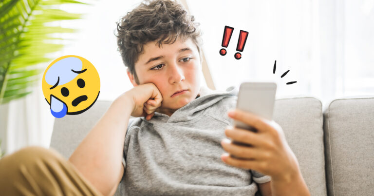 teen boy looking at phone with sad expression