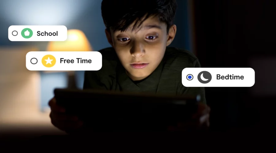 image of young boy in a dark room looking at screen