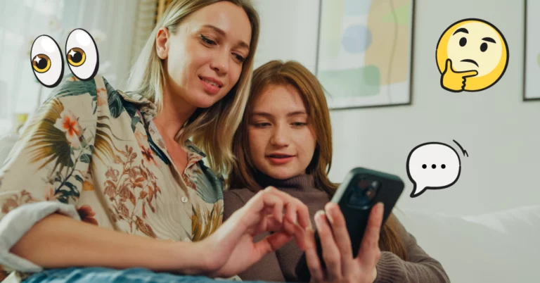 Mom and daughter looking at a phone together with emojis around them