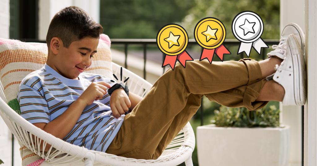 kid sitting and looking down at his smartwatch