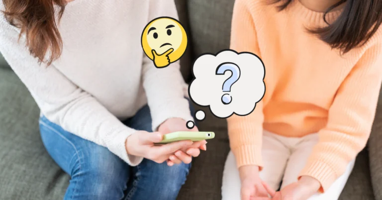 mom and daughter sitting and looking at a smartphone
