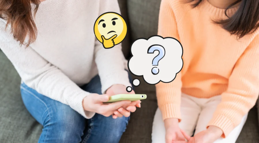 mom and daughter sitting and looking at a smartphone