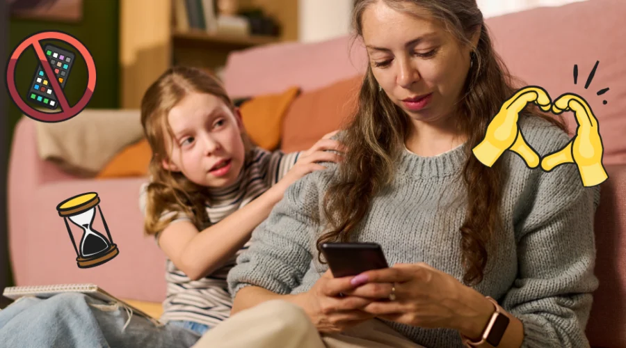 mom on phone next to daughter