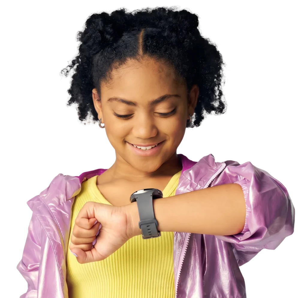 A smiling girl in a pink jacket wearing the Bark Watch, a GPS smartwatch for kids