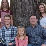 A family portrait of a husband, wife, and three kids