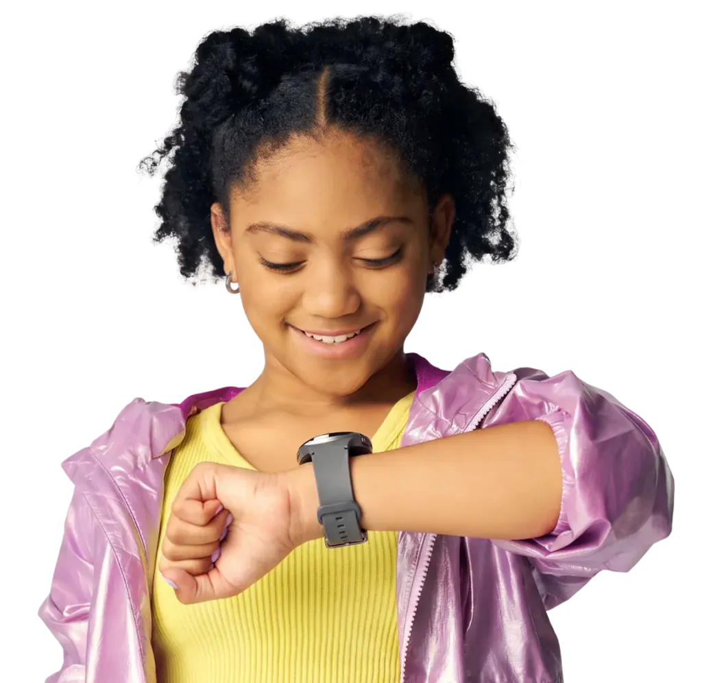 A smiling girl in a pink jacket wearing the Bark Watch, a GPS smartwatch for kids